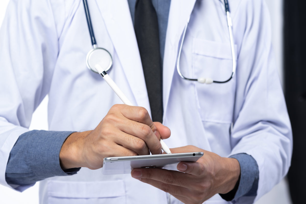 Doctor Wrting On The Tablet - Medical Cannabis - Cannabiz