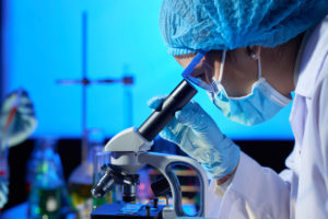 Researcher Looking Through A Microscope - Medical Cannabis Australia - Cannabiz
